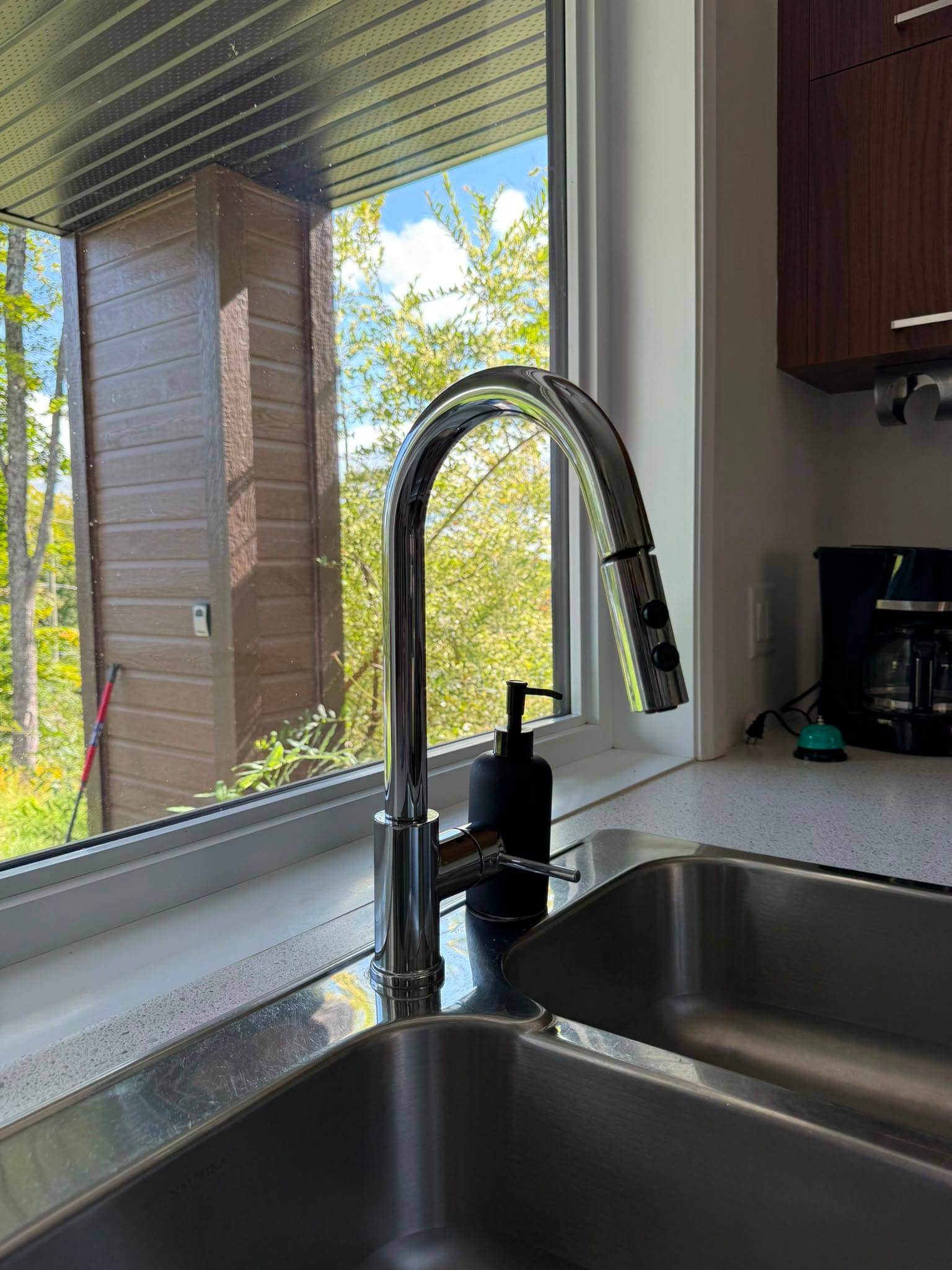 Kitchen window overlooking the forest at a rental property
